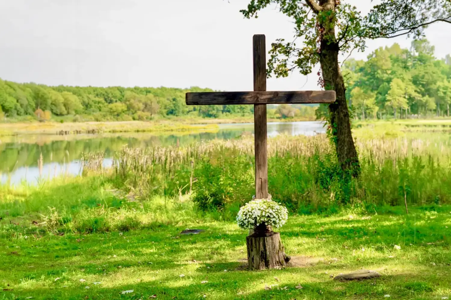 A wood cross at the waterfront ceremony site at Old Coon Creek Wedding Venue, Beloit, Wisconsin